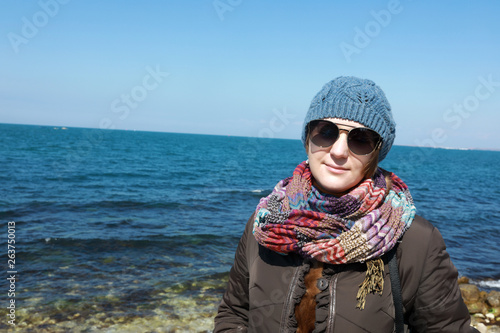 Woman posing on black sea background © Arkady Chubykin