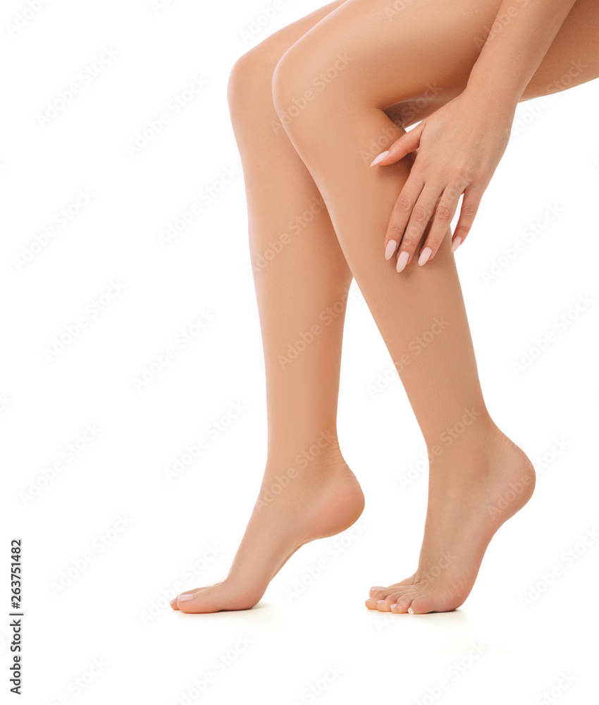 Woman touching her beautiful slim smooth shaved legs close-up. Woman touching her beautiful slim smooth shaved legs close-up.