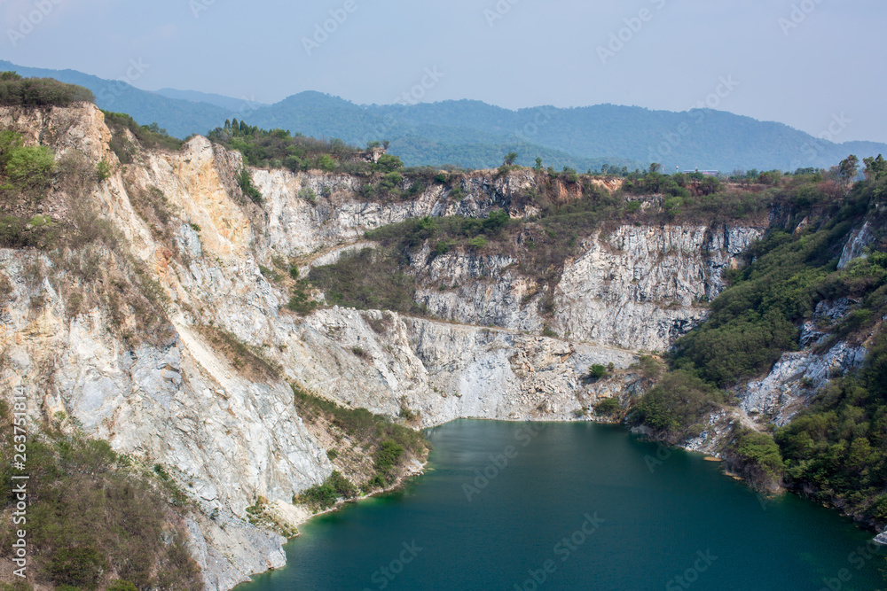Canyon tourist famous cliff jumping spot with red cliff and blue water. view of lake in Canyon Mountain. Lake with turquoise blue water and mountains landscape. Summer Mountain landscape with Lake