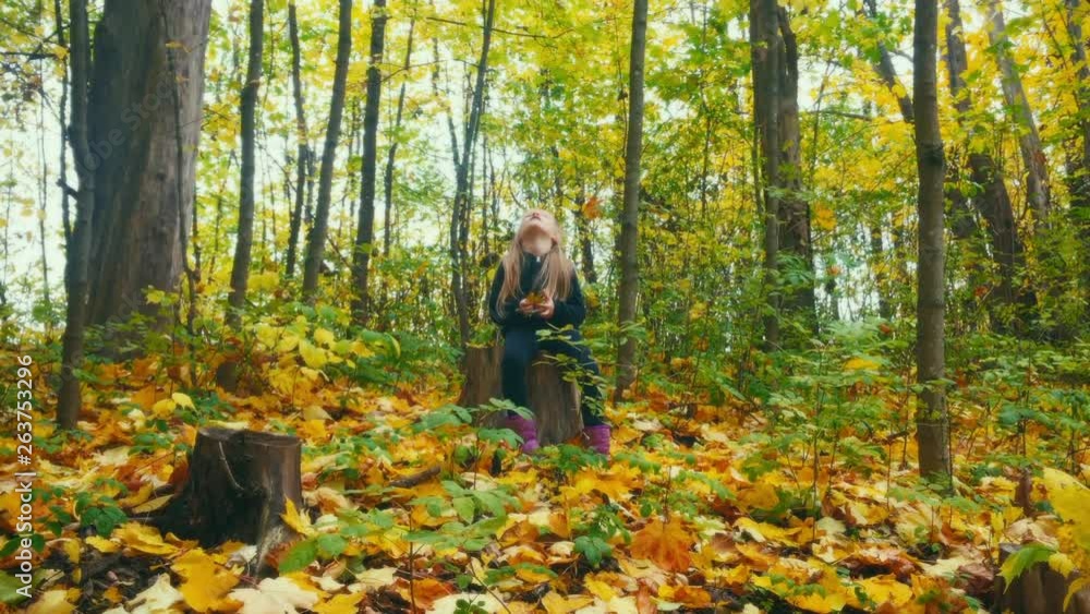 Girl sitting on a trunk tired and lloking up to the trees. Girl sitting on a trunk tired and lloking up to the trees.