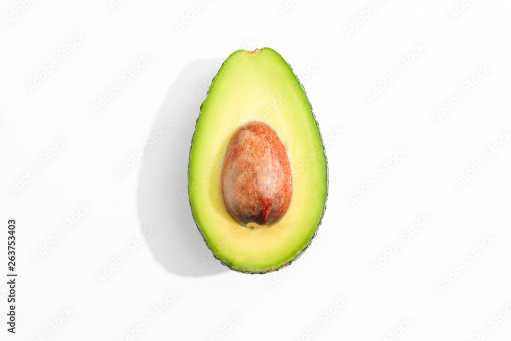 Rip cut avocado on white background, space for text