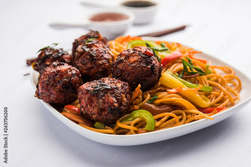 Manchurian Hakka / Schezwan noodles, popular indochinese food served in a bowl. selective focus Manchurian Hakka / Schezwan noodles, popular indochinese food served in a bowl. selective focus