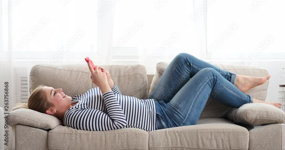 Relaxed woman blowing a kiss while video chatting on phone Relaxed woman blowing a kiss while video chatting on phone