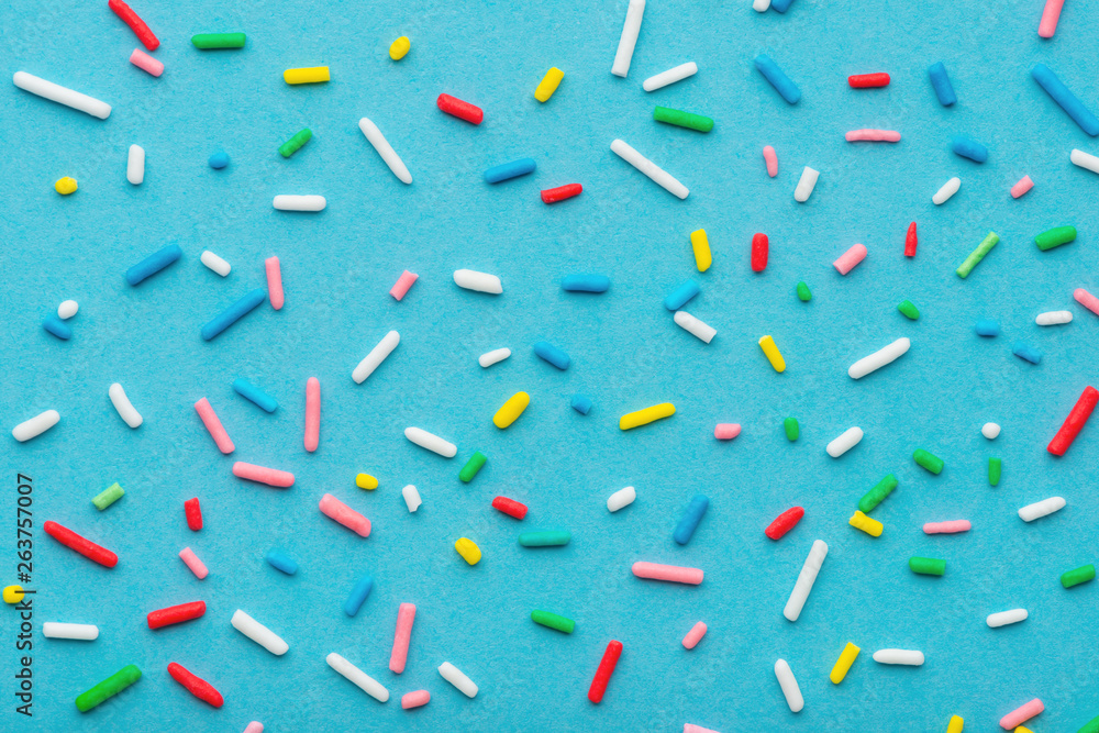 colorful sprinkles over blue background, decoration for cake and bakery - obrazy, fototapety, plakaty 