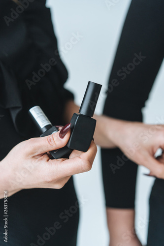 Woman holds black mascara in her hand