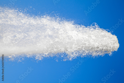 water jet against the blue sky. powerful stream of clean water