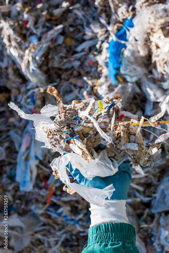 Close up of man holding shredded municipal waste used as alternative fuel photo