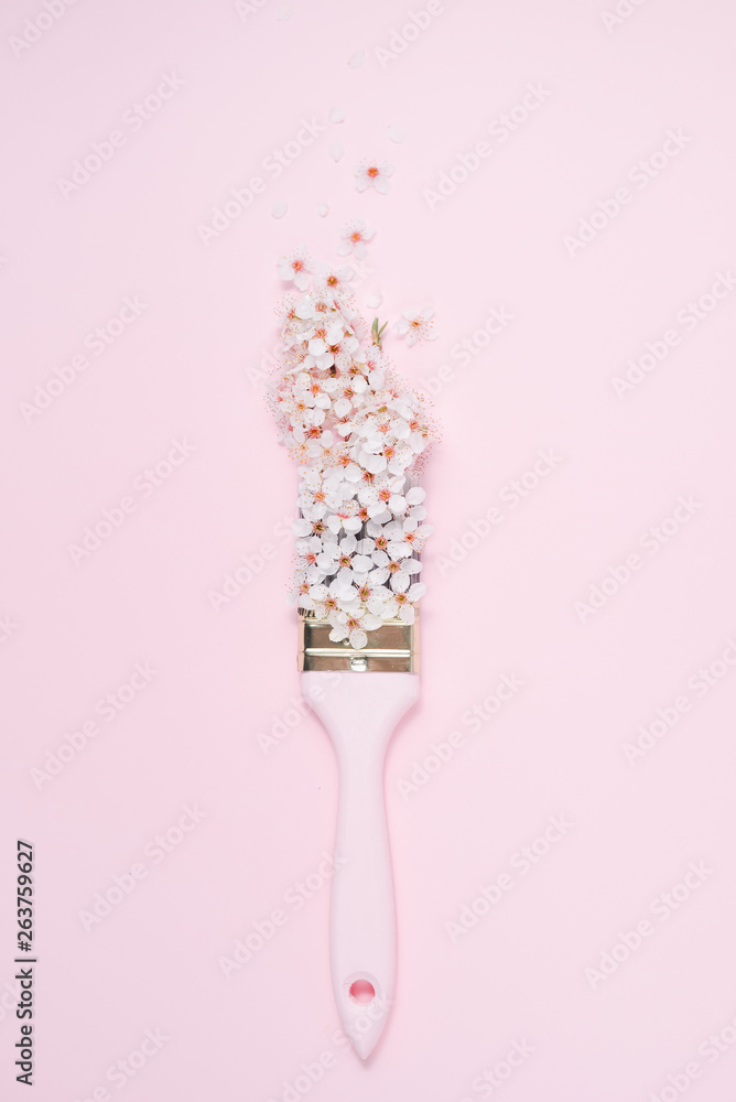 Blossom arrangement following a trace of a Paintbrush on pink background. Flat lay, top view, copy space Blossom arrangement following a trace of a Paintbrush on pink background. Flat lay, top view, copy space
