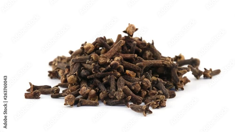 Pile of cloves rotating on white background - cloves are used as seasoning in the kitchen Pile of cloves rotating on white background - cloves are used as seasoning in the kitchen