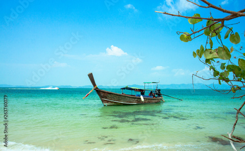 Seascape with transparent azure water and traditional thai boat. Azure lagoon in Thailand. Andaman Sea.