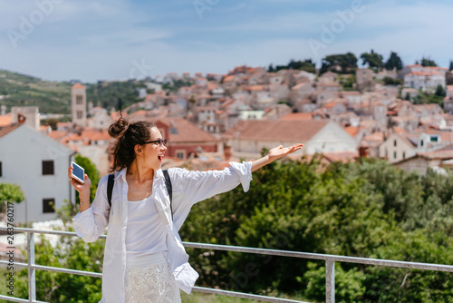 Young beautiful woman on the background of a small Croatian town