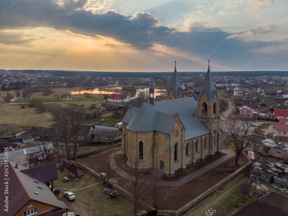 The church in sunset light. Rakov, Belarus. Drone aerial photo
