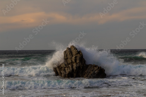 rock in the sea, which is hit by the waves. On the beach of Atxabiribil in Sopelana photo