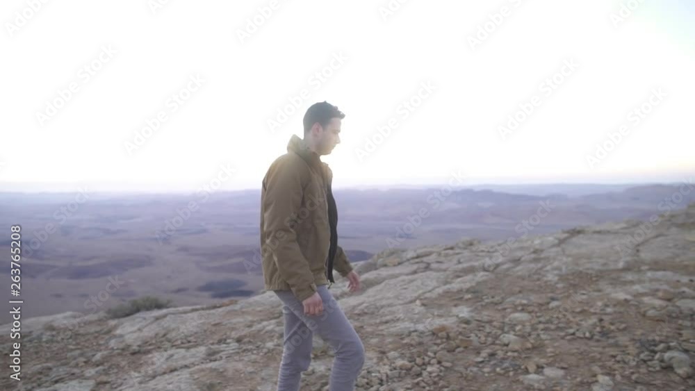 Man walking in the desert with beautiful early morning background Man walking in the desert with beautiful early morning background
