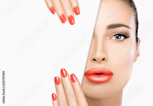 Beauty woman face closeup. Manicured nail. Full lips. Perfect skin.