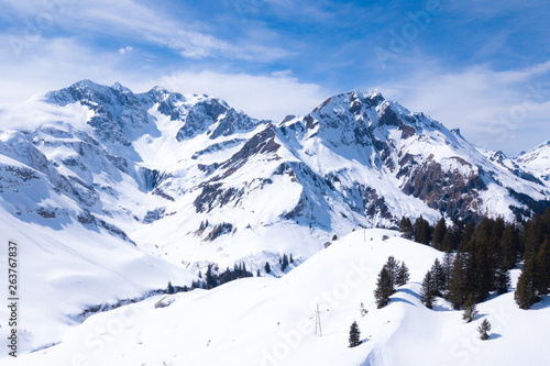 winter landscape with blue sky in austria by drone