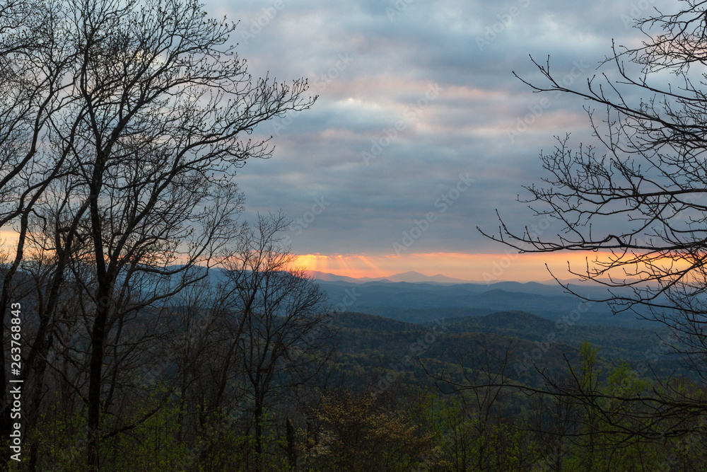 Sunrise through the clouds over the Georgia Blue Ridge Mountains from Hike Inn in the Chattahoochee National Forest in early spring.