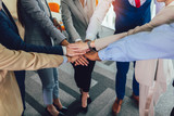 Large business team showing unity with their hands together. Selective focus