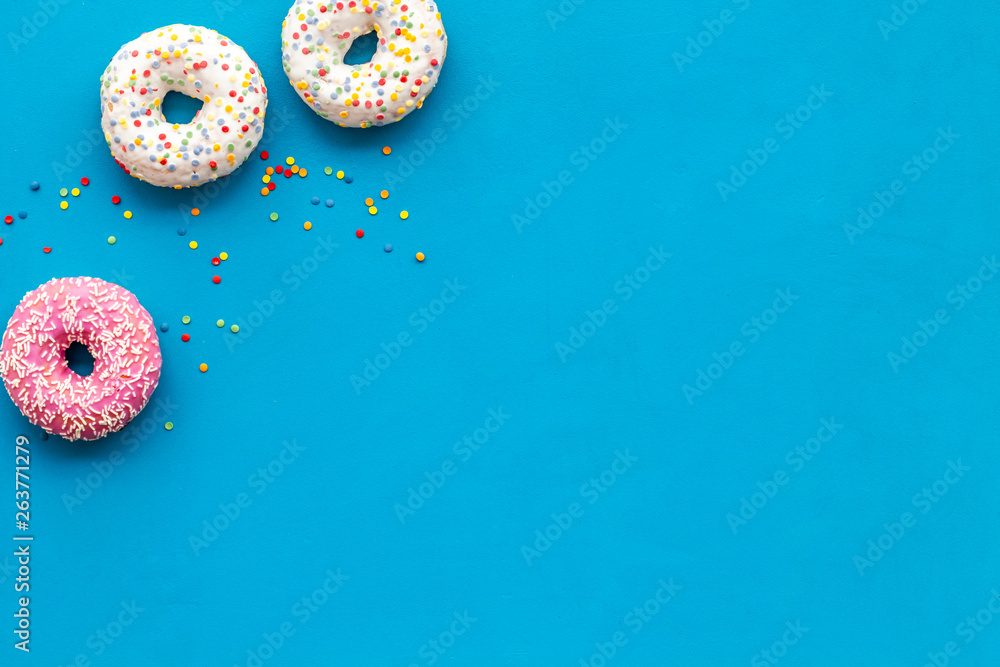 Modern design with bright donuts on blue background top view mock up Modern design with bright donuts on blue background top view mock up