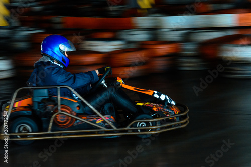 Dynamic karting competition at speed with blurry motion on an equipped racecourse