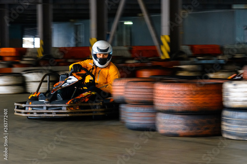 Dynamic karting competition at speed with blurry motion on an equipped racecourse