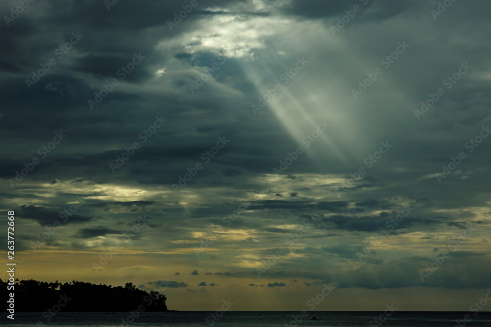 The sun's rays at sunset making their way through the clouds. The sun's rays at sunset making their way through the clouds.