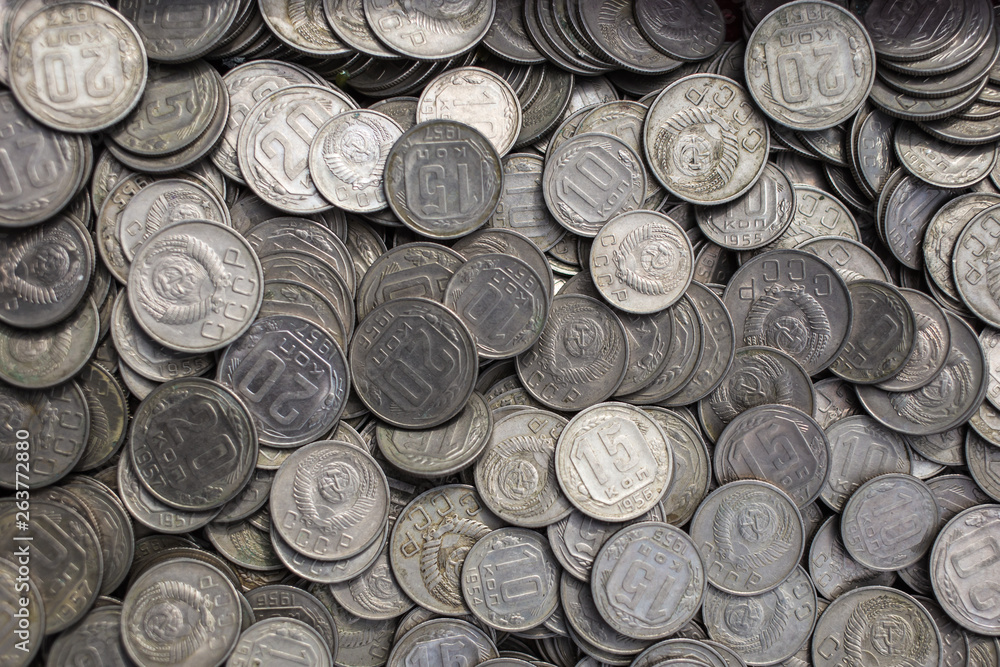 Soviet coins sprinkled on the whole frame of the photo. The USSR ruble. Old coins for numismatics