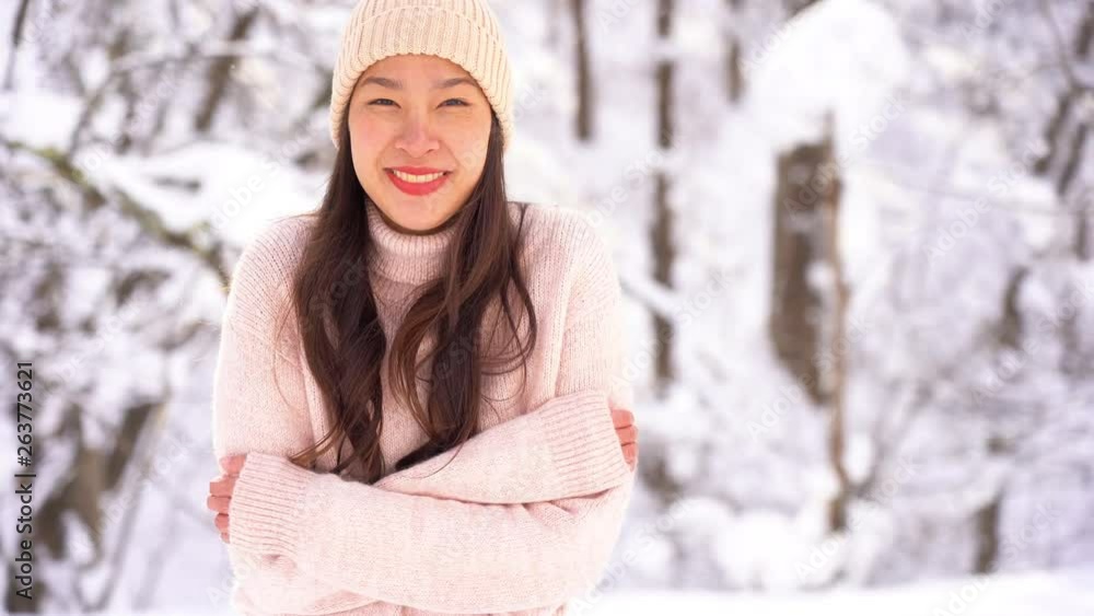 Young asian woman smile and happy in snow winter season Young asian woman smile and happy in snow winter season