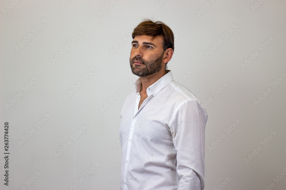 Fashion portrait of handsome young man with brown hair in love, facing forwards and looking at the horizon. Isolated on white background. Fashion portrait of handsome young man with brown hair in love, facing forwards and looking at the horizon. Isolated on white background.