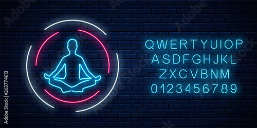 Neon glowing sign of yoga exercices club with lotus pose with alphabet. Street lights signboard of gymnastics
