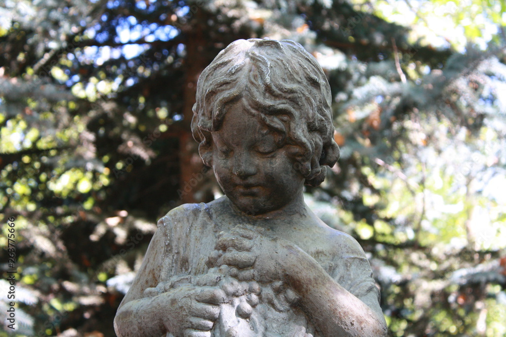 statue of  a girl in a garden