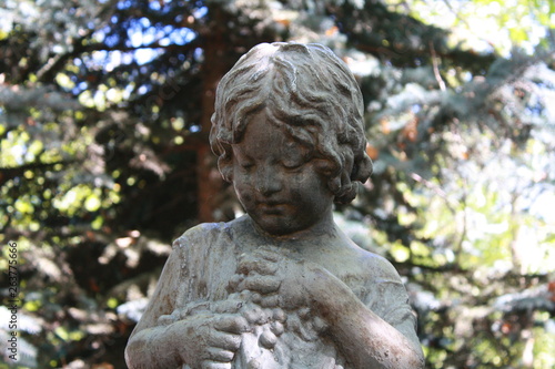 statue of  a girl in a garden