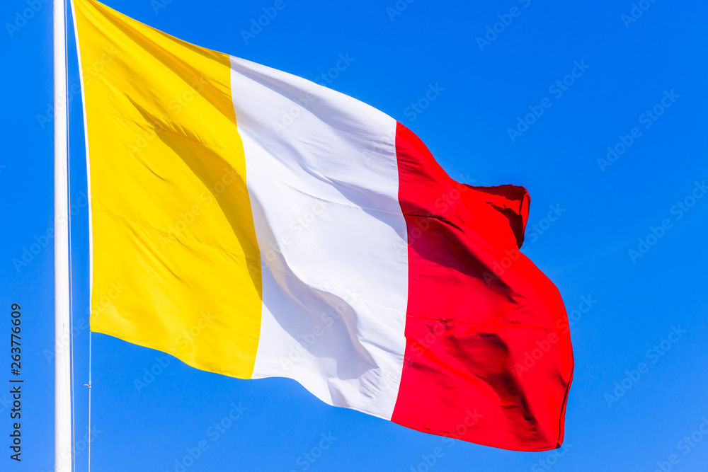 A flag with gold/yellow, white and red vertical stripes. Stock Photo |  Adobe Stock