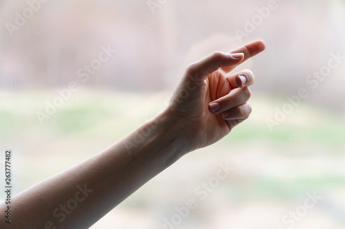 Hand of woman in gesture isolated on blurred background © 0804Creative