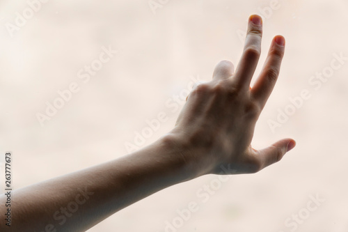 Hand of woman in gesture isolated on blurred background