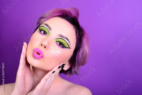 Sexy girl with short hair. Portrait of a woman with bright colored hair, all shades of purple. Beautiful lips and makeup. tubule shaped lips. Professional coloring. professional makeup.