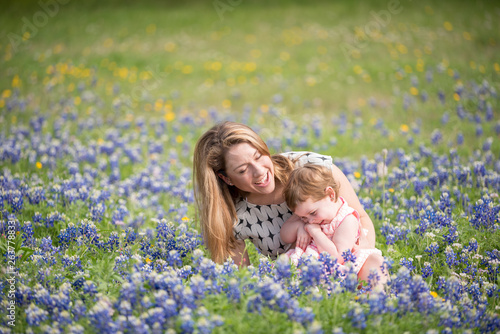 Young Millennial Mother With Daughter During Spring in a Field of Blue Bonnets