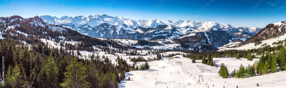 Beautiful winter landscape. People skiing in Mythenregion ski resort, Ibergeregg, Switzerland, Europe