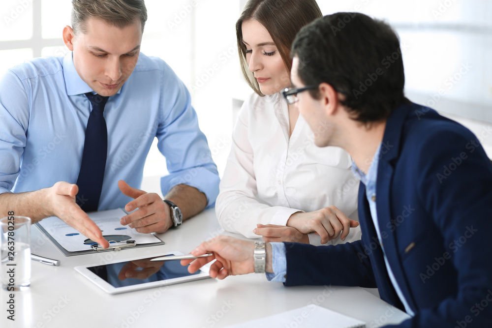Group of business people discussing questions at meeting in modern office. Managers at negotiation or brainstorm. Teamwork, partnership and business concept Group of business people discussing questions at meeting in modern office. Managers at negotiation or brainstorm. Teamwork, partnership and business concept