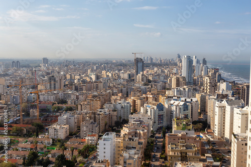 Aerial view of a residential neighborhood in a city during a cloudy and sunny sunrise. Taken in Netanya, Center District, Israel. © edb3_16