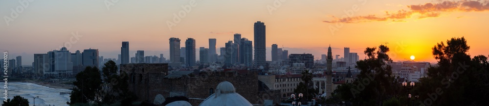 Panoramic view of a modern downtown city during a colorful sunrise. Taken in Jaffa, Tel Aviv-Yafo, Israel,