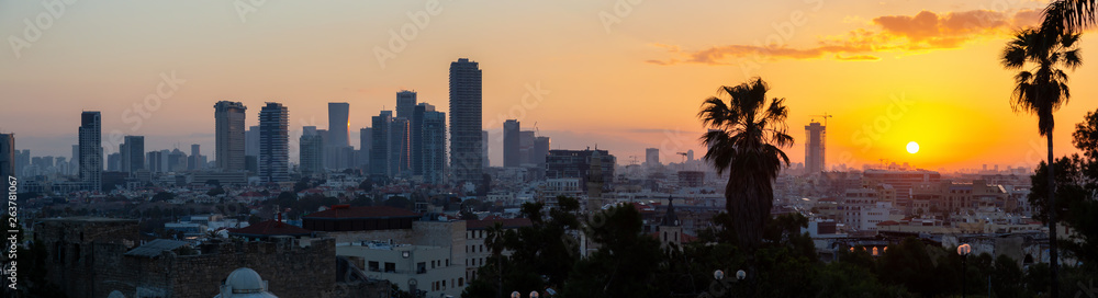 Panoramic view of a modern downtown city during a colorful sunrise. Taken in Jaffa, Tel Aviv-Yafo, Israel,