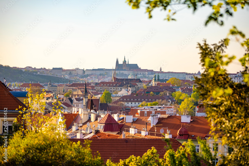 View of Prague Castle over red roof from Vysehrad area at sunset lights, Prague, Czech Republic