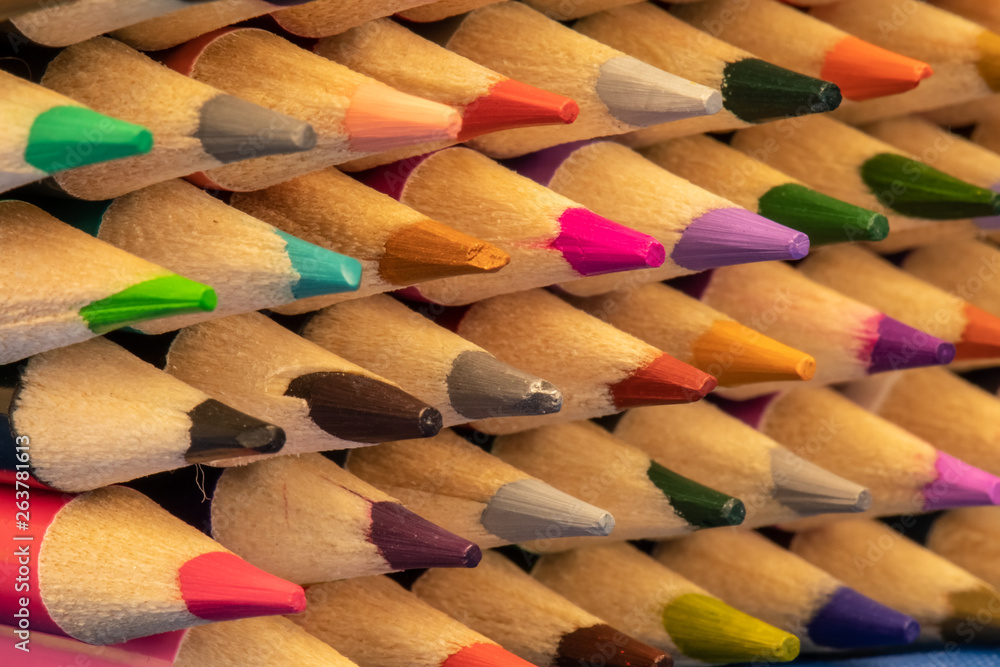 Colored pencils with sharpened points lined in rows. Colored pencils with sharpened points lined in rows.