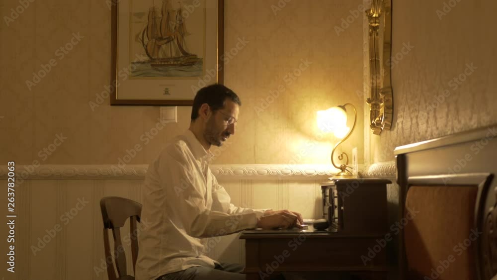 Man in white shirt finish writing taking off the glasses and putting them in the drawer. Man in white shirt finish writing taking off the glasses and putting them in the drawer.