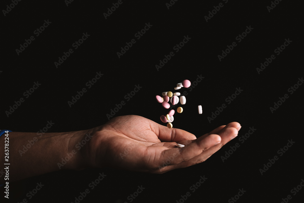 pills in hand on black background pills in hand on black background