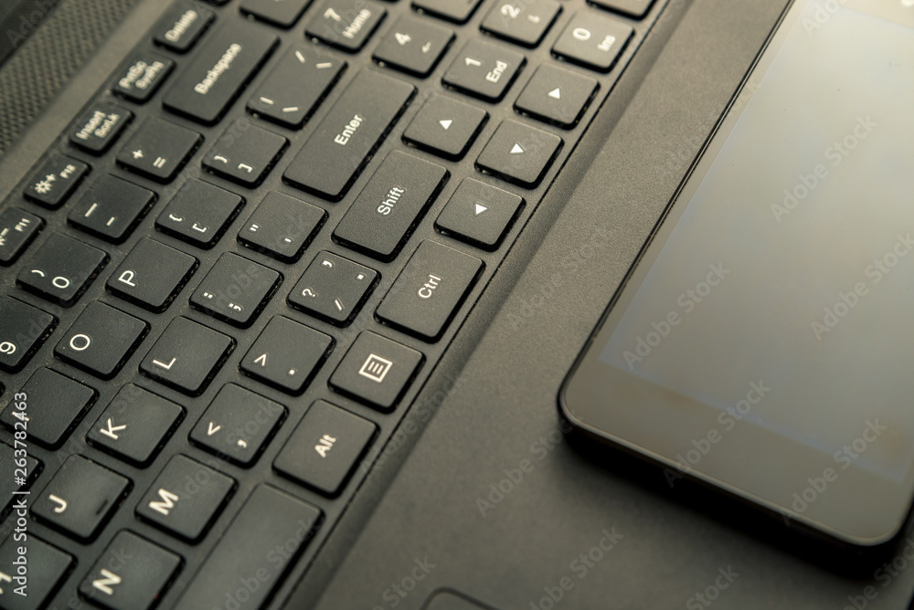Modern technology and gadgets, phone and laptop are on a wooden background. Modern technology and gadgets, phone and laptop are on a wooden background.