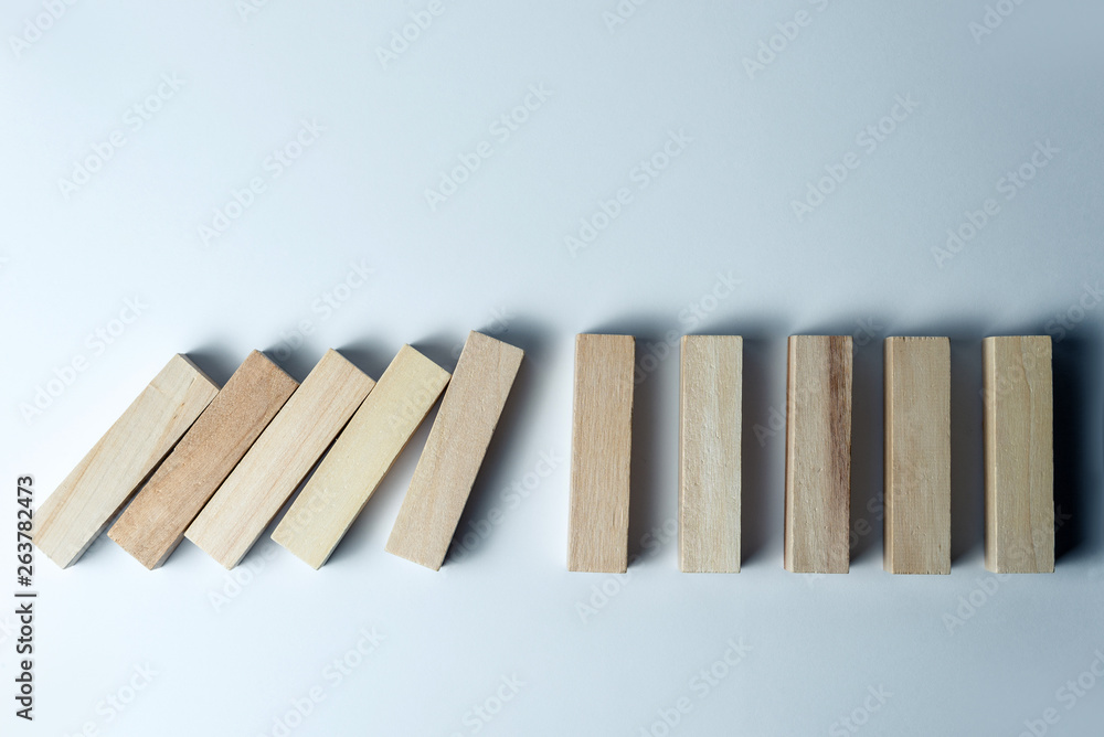 Falling wooden cubes, as a symbol of defeat, wrong decision and collapse, on an uneven white background. Horizontal frame Falling wooden cubes, as a symbol of defeat, wrong decision and collapse, on an uneven white background. Horizontal frame