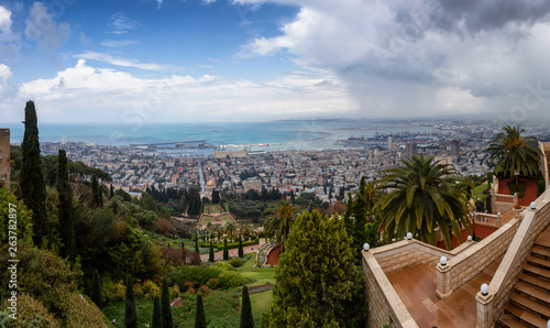 Beautiful panoramic view of Bahai Gardens and a city on the coast of Mediterranean Sea during a cloudy day. Taken in Haifa, Israel.