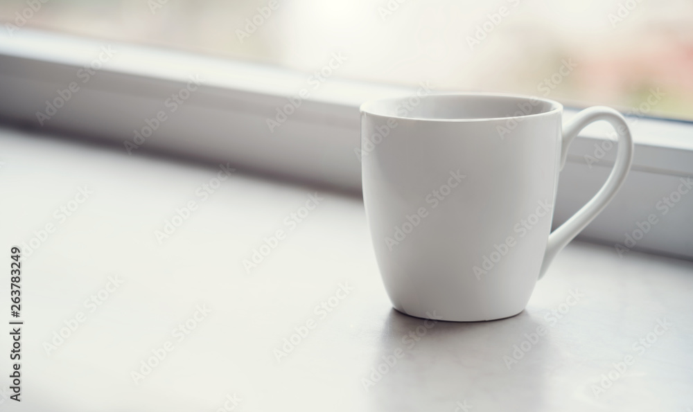 White blank Mug on windowsill at morning White blank Mug on windowsill at morning